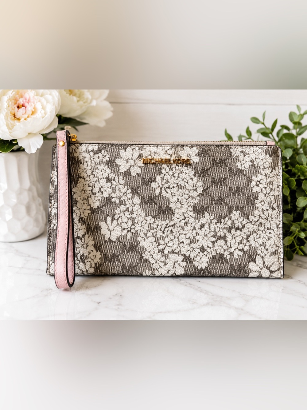 Michael Kors Jet Set wristlet with a delicate floral design and a  wrist strap